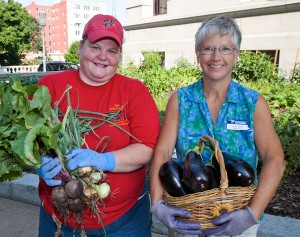 Volunteers holding vegetables